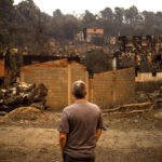 Un vecino observa los destrozos hechos por el fuego en la comarca de Valdeorras, Ourense, en el verano de 2025.