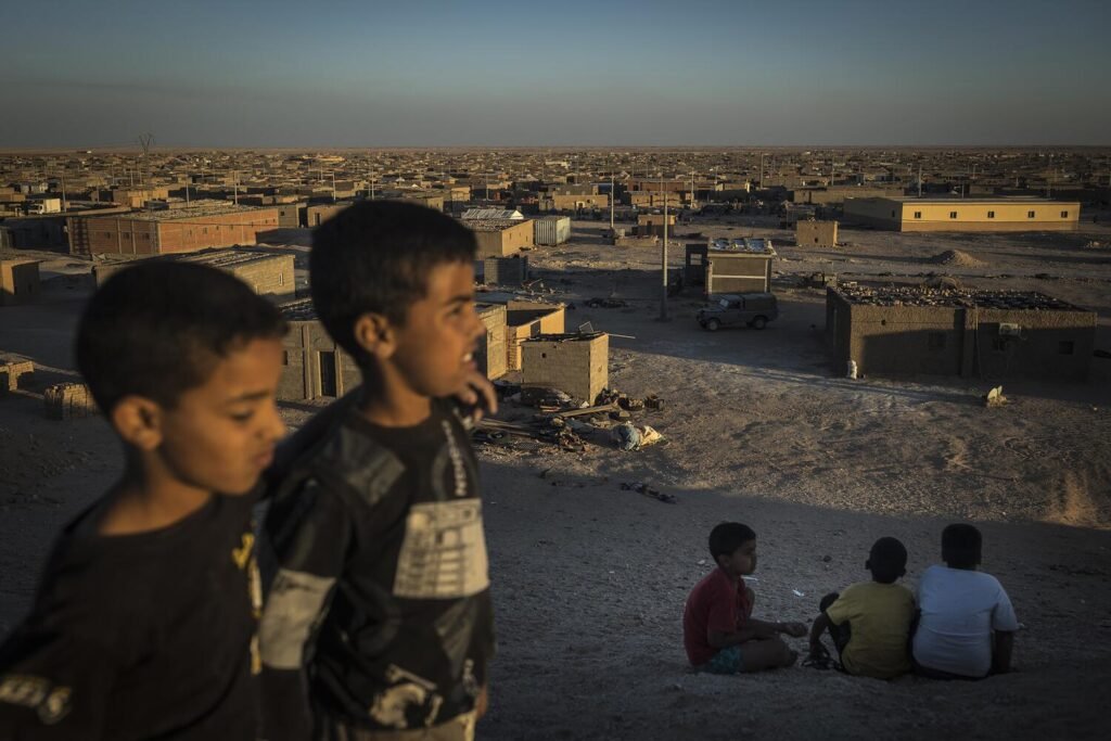 Varios niños juegan a deslizarse por una colina en las afueras del campamento de refugiados saharauis de Esmara. Con más de 50.000 habitantes, esta es la wilaya (provincia) más poblada de las cinco que se establecieron tras el éxodo saharaui en la región de Tinduf, Argelia, después de los bombardeos con napalm y fósforo blanco que las tropas marroquíes lanzaron contra la población civil saharaui durante su ocupación. Jairo Vargas.