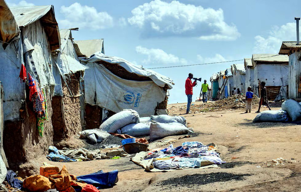 Richard Mbagaro, supervisor del campamento de Kigonze para desplazados internos, se dirige por megáfono a los residentes, instándolos a lavarse las manos con jabón o ceniza ante el creciente temor a la propagación del ébola, en Bunia (RDC).