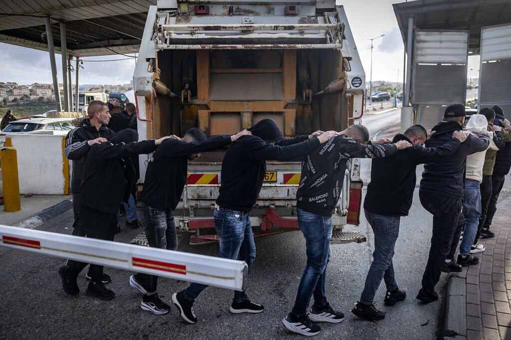 Agentes de la policía fronteriza israelí detienen a palestinos que intentaban entrar ilegalmente en Israel para trabajar tras esconderse dentro de un camión de basura, en el puesto de control de Al-Za'im, Jerusalén.