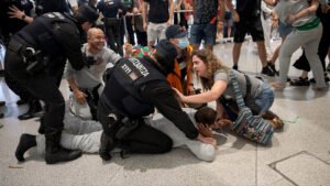 La Ertzaintza carga contra activistas de la Flotilla en el aeropuerto de Bilbao.
