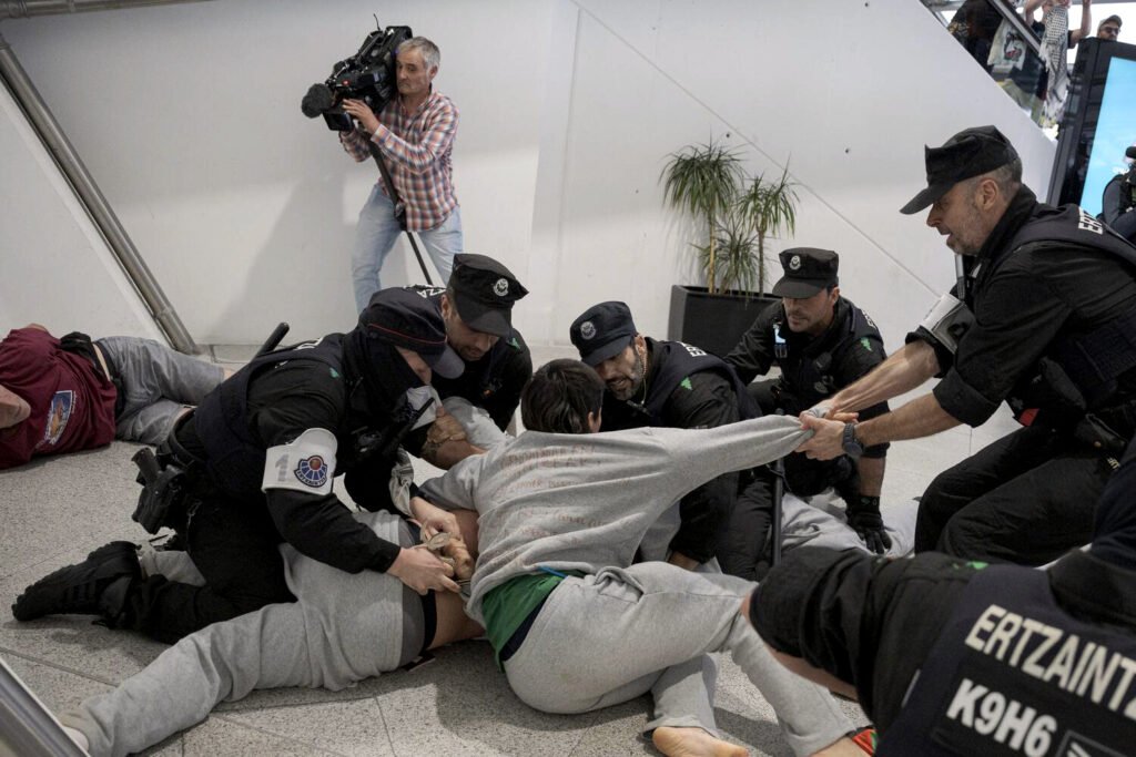 La Erztzaintza carga contra los militantes de la flotilla a su llegada al aeropuerto de Loiu.
