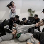 La Erztzaintza carga contra los militantes de la flotilla a su llegada al aeropuerto de Loiu.