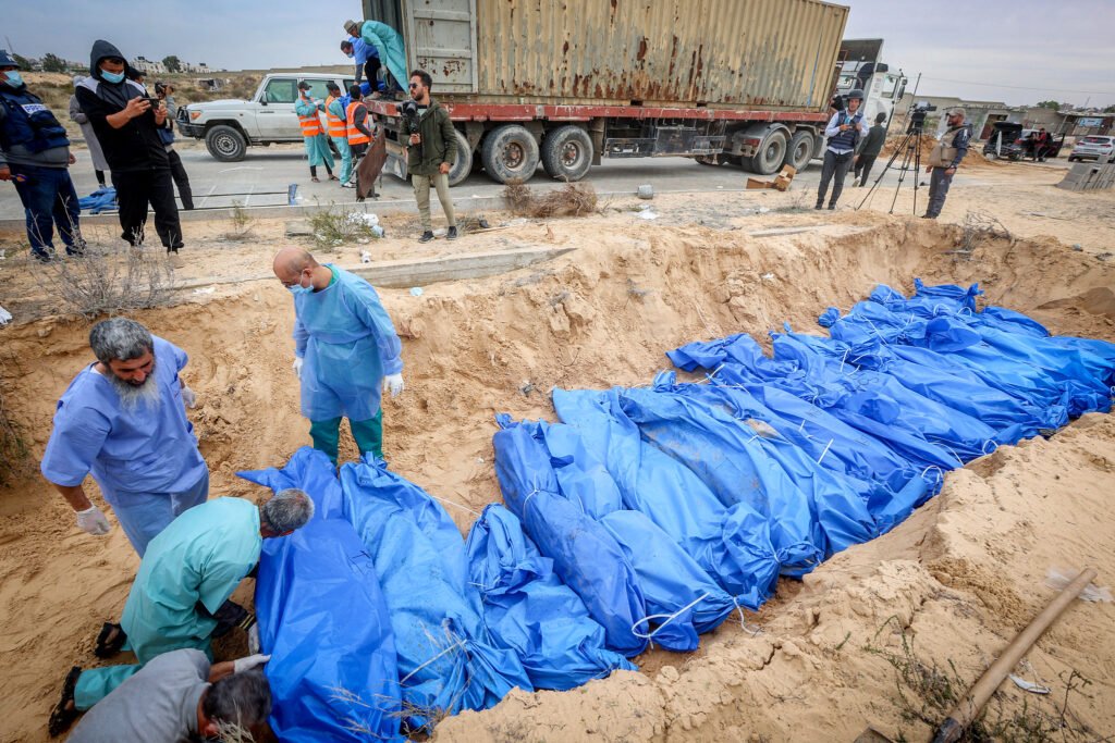 Palestinos entierran cadáveres en una fosa común en Khan Younis, al sur de la Franja de Gaza.