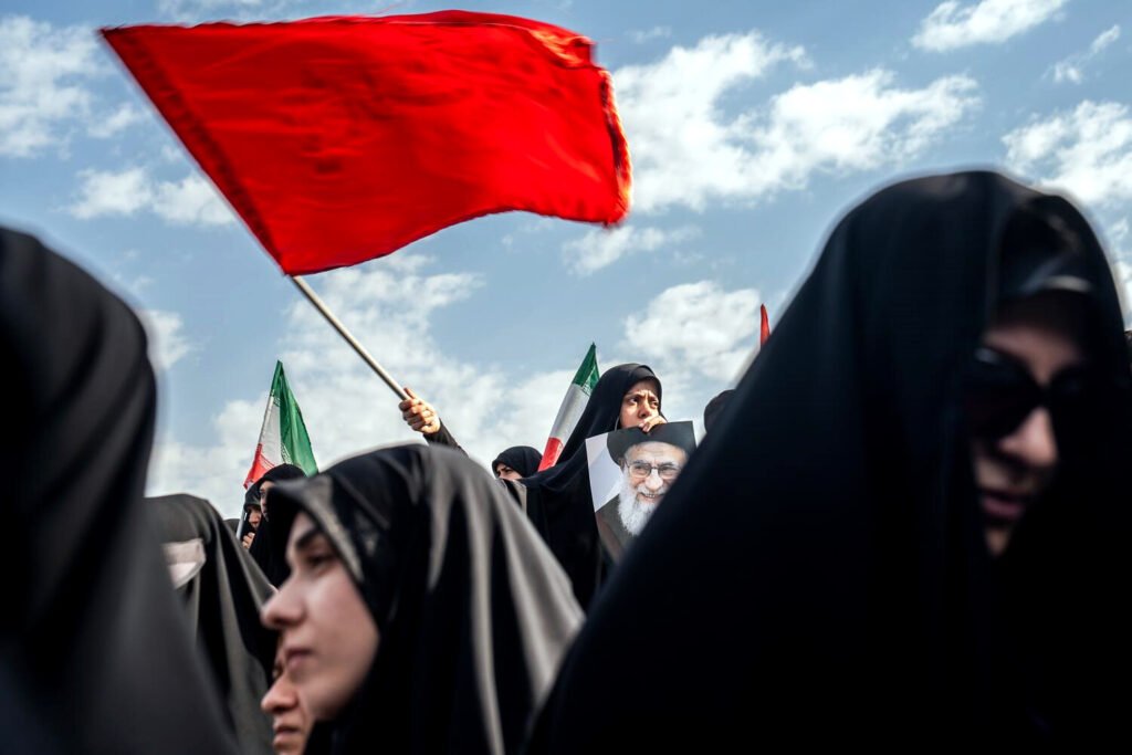 Una joven con el retrato del ayatolá durante la ceremonia fúnebre en Teherán.